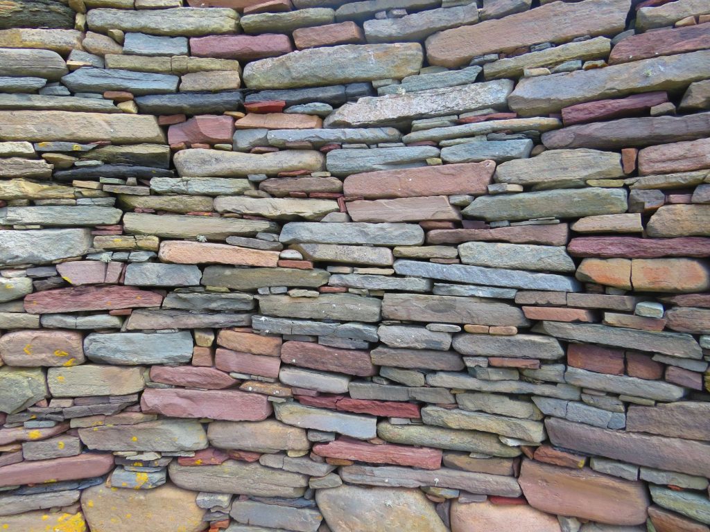 Picture of a multi-coloured stacked stone wall