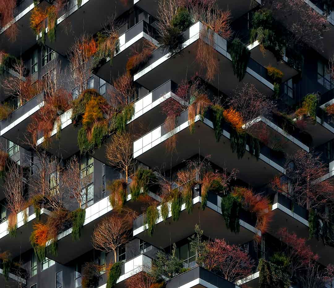 Organization Design | Organizational Design High rise building with plants and trees on the balconies.